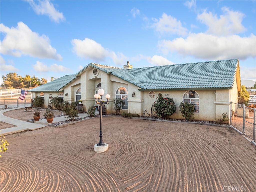 6370 Fremontia Road Hesperia, CA 92344 - Photo 2 of 62 a front view of a house with a yard