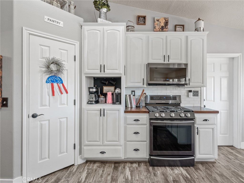 6370 Fremontia Road Hesperia, CA 92344 - Photo 27 of 62 a kitchen with stainless steel appliances a stove a cabinets and a window