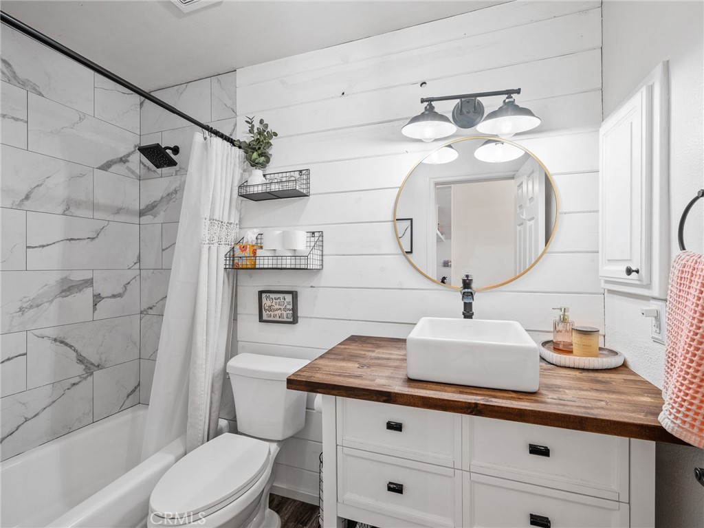 6370 Fremontia Road Hesperia, CA 92344 - Photo 29 of 62 a bathroom with a granite countertop toilet sink and mirror