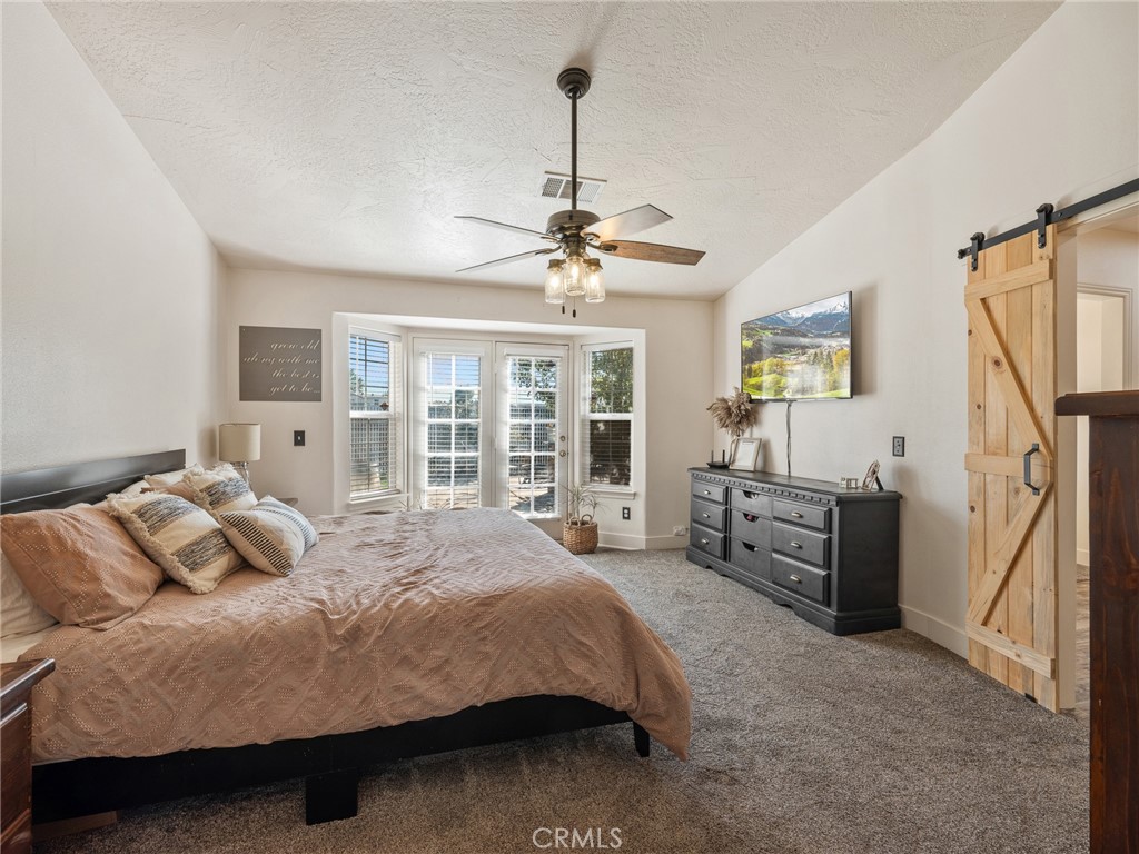 6370 Fremontia Road Hesperia, CA 92344 - Photo 30 of 62 a bedroom with a bed couch and a large window