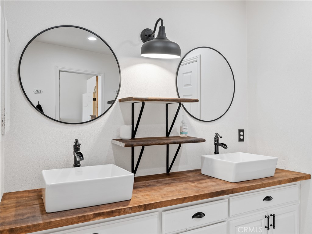 6370 Fremontia Road Hesperia, CA 92344 - Photo 33 of 62 a bathroom with a sink a mirror and a window