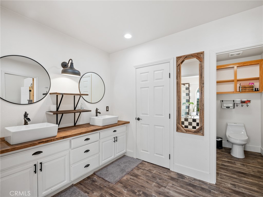 6370 Fremontia Road Hesperia, CA 92344 - Photo 34 of 62 a bathroom with a toilet a sink and a mirror