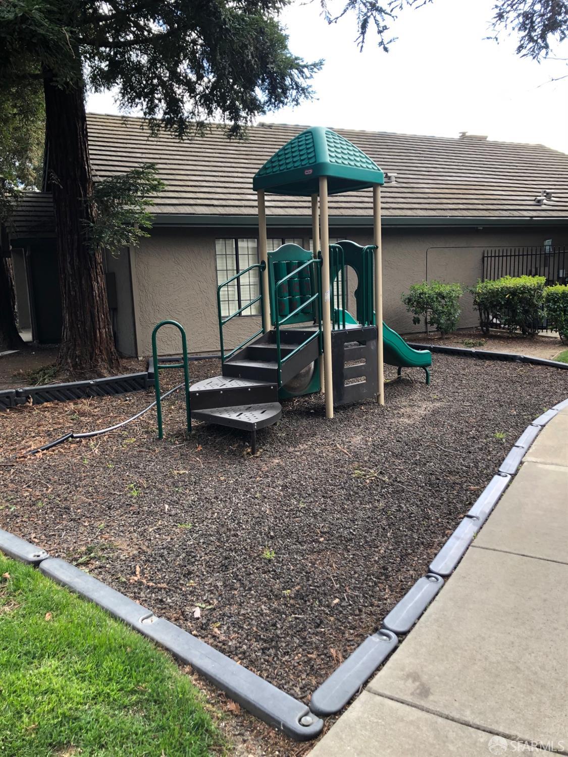 2181 Lakeview Circle Pittsburg, CA 94565 - Photo 16 of 17 a view of a backyard with table and chairs under an umbrella