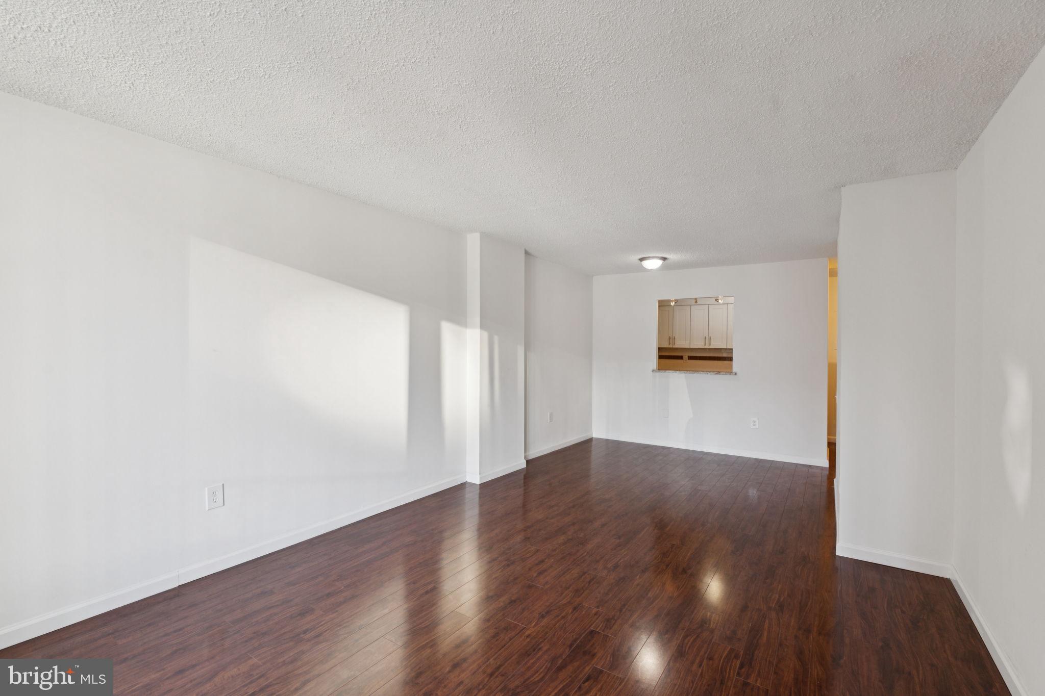 1420 Locust Street, Unit 7L Philadelphia, PA 19102 - Photo 3 of 25 a view of a big room with wooden floor and windows