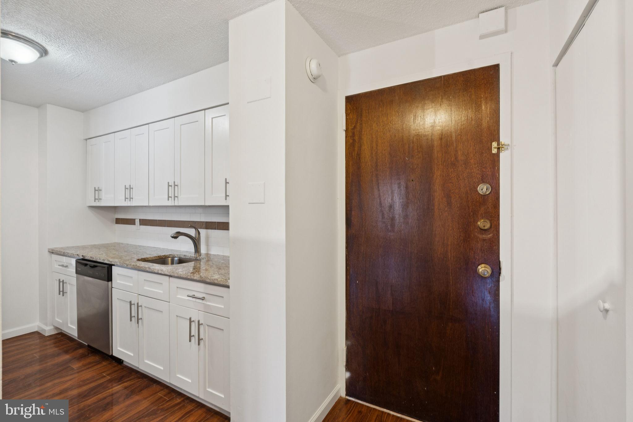 1420 Locust Street, Unit 7L Philadelphia, PA 19102 - Photo 4 of 25 a kitchen with white cabinets and sink