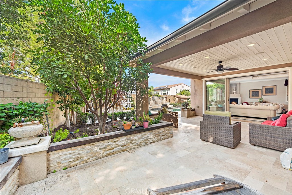108 Fairgrove Irvine, CA 92618 - Photo 14 of 40 a view of a patio with table and chairs potted plants and floor to ceiling window