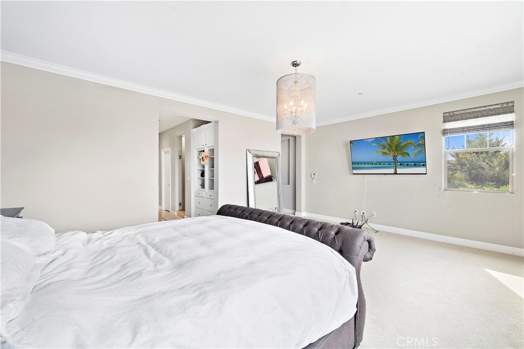 108 Fairgrove Irvine, CA 92618 - Photo 27 of 40 a bedroom with a bed and a chandelier