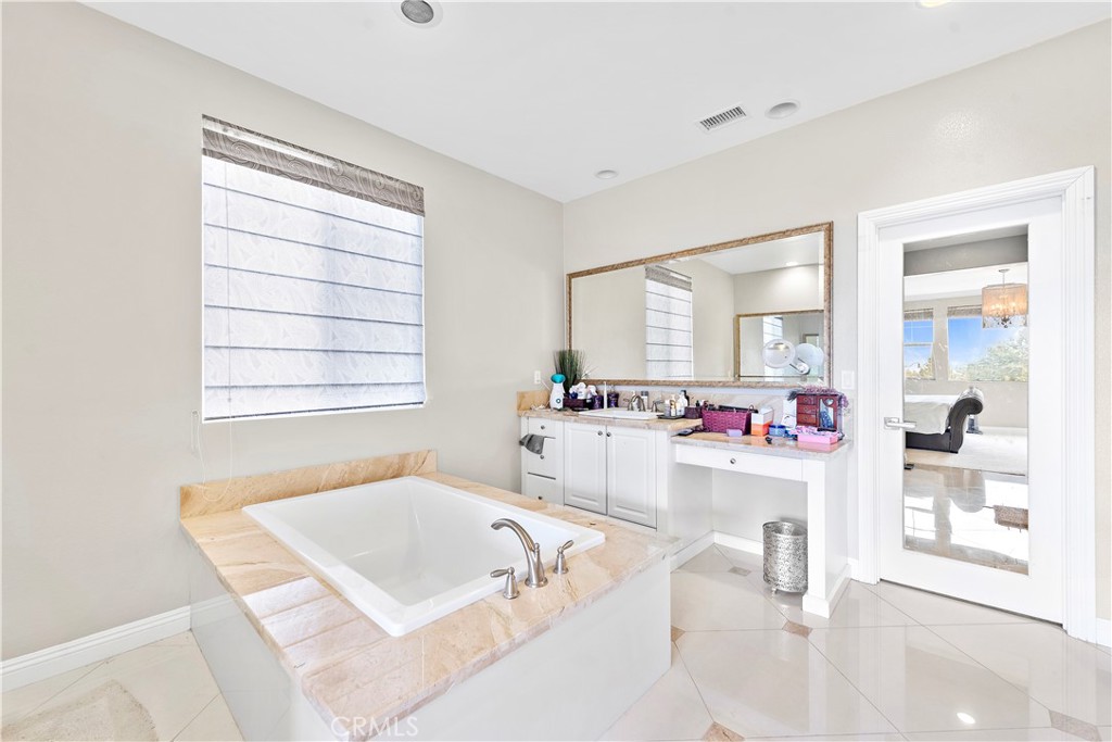 108 Fairgrove Irvine, CA 92618 - Photo 28 of 40 a bathroom with a tub sink and mirror