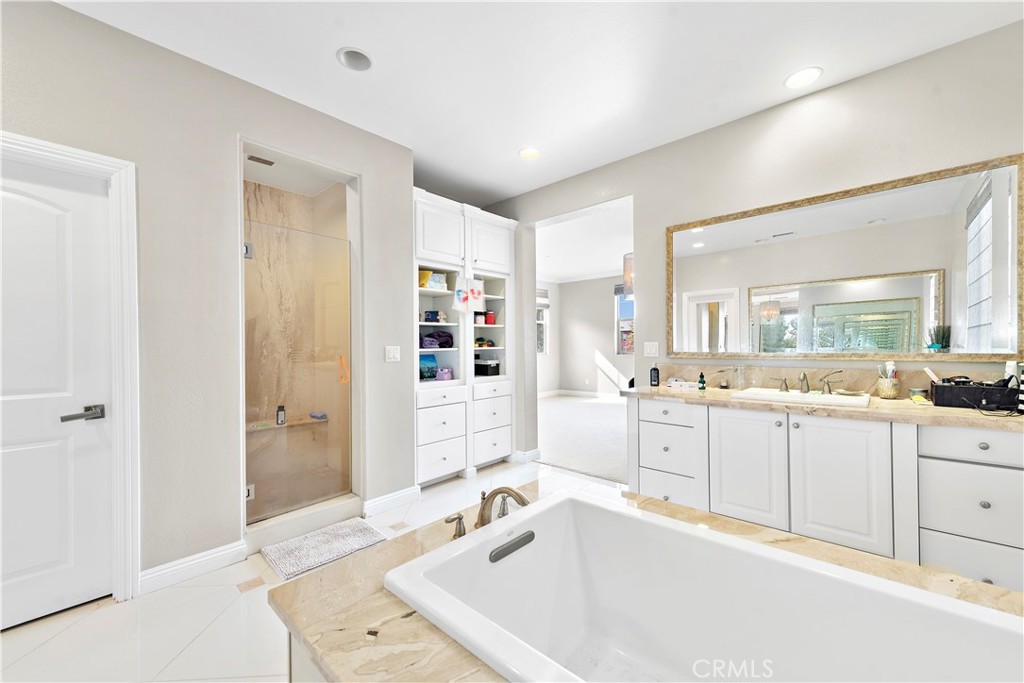 108 Fairgrove Irvine, CA 92618 - Photo 30 of 40 a large white bathroom with a granite countertop double vanity sink a mirror and a bathtub