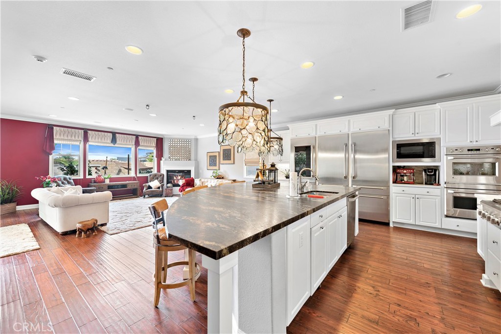 108 Fairgrove Irvine, CA 92618 - Photo 6 of 40 a kitchen with kitchen island granite countertop lots of counter top space and stainless steel appliances