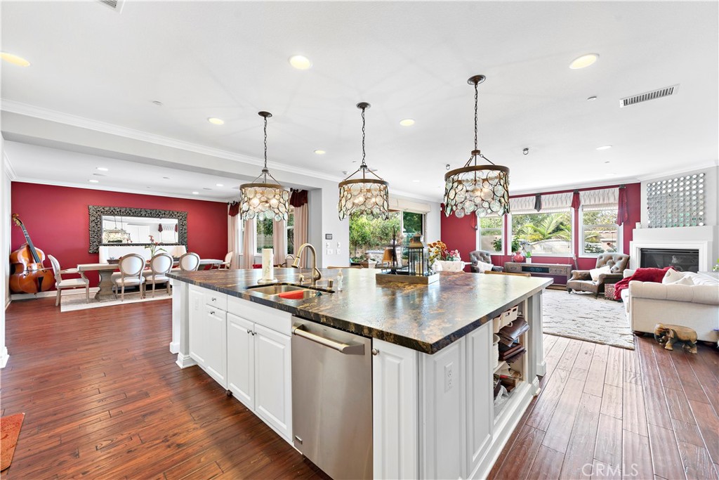 108 Fairgrove Irvine, CA 92618 - Photo 7 of 40 a kitchen with stainless steel appliances granite countertop a sink stove and wooden floor