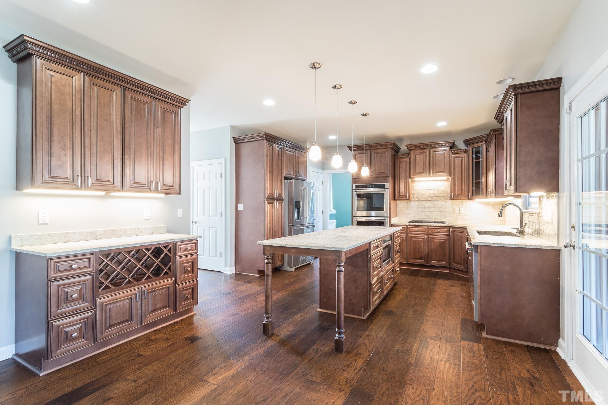6023 Clapton Drive Wake Forest, NC 27587 - Photo 12 of 35 a kitchen with stainless steel appliances granite countertop a stove a sink dishwasher and a refrigerator