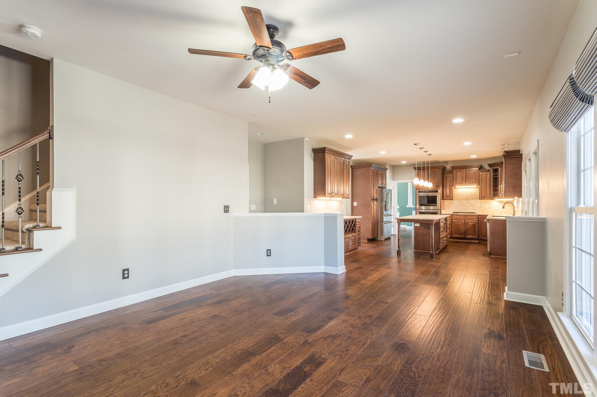 6023 Clapton Drive Wake Forest, NC 27587 - Photo 13 of 35 a view of a living room kitchen with furniture and a ceiling fan