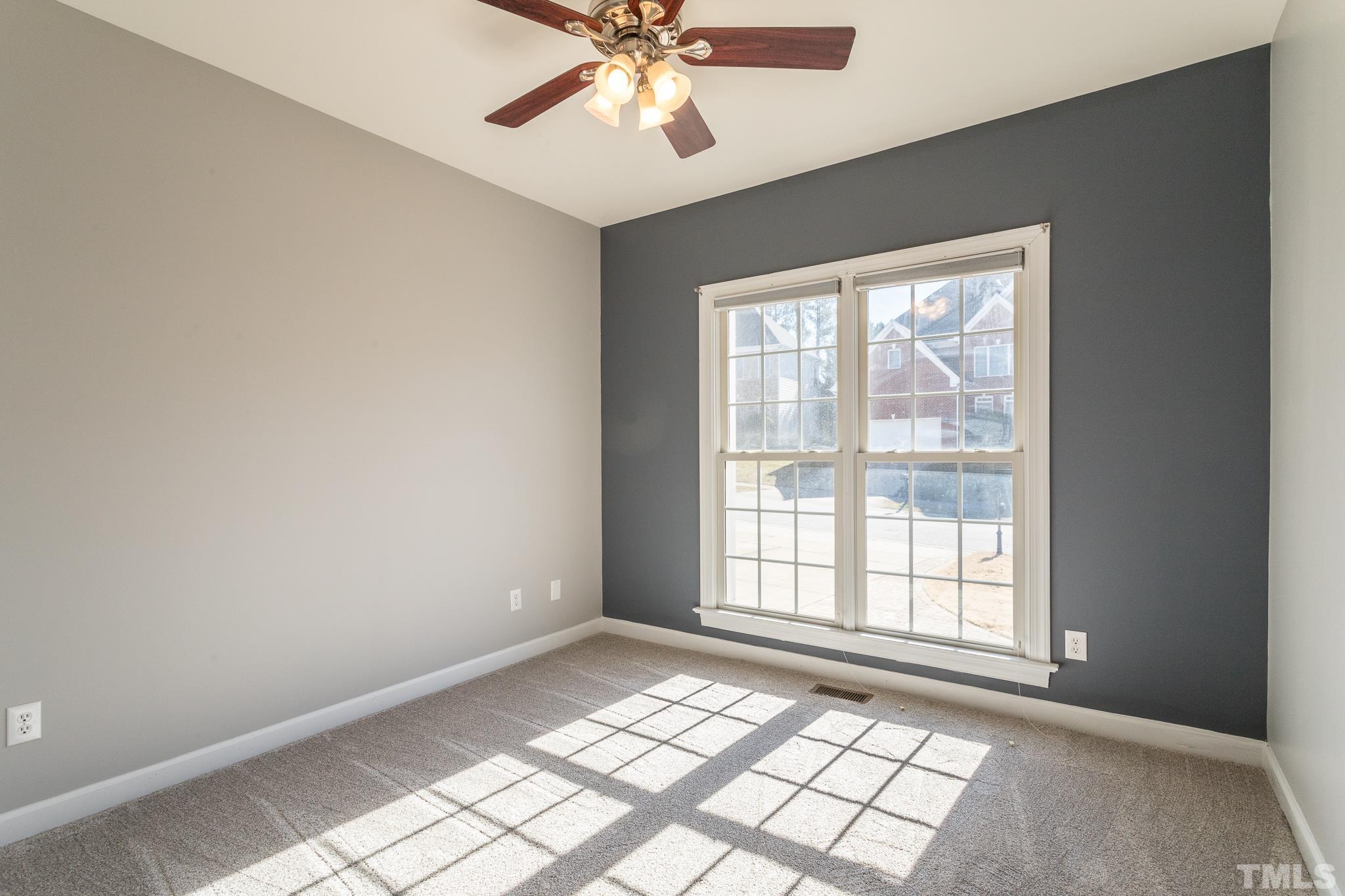6023 Clapton Drive Wake Forest, NC 27587 - Photo 20 of 35 a view of an empty room with window and chandelier fan