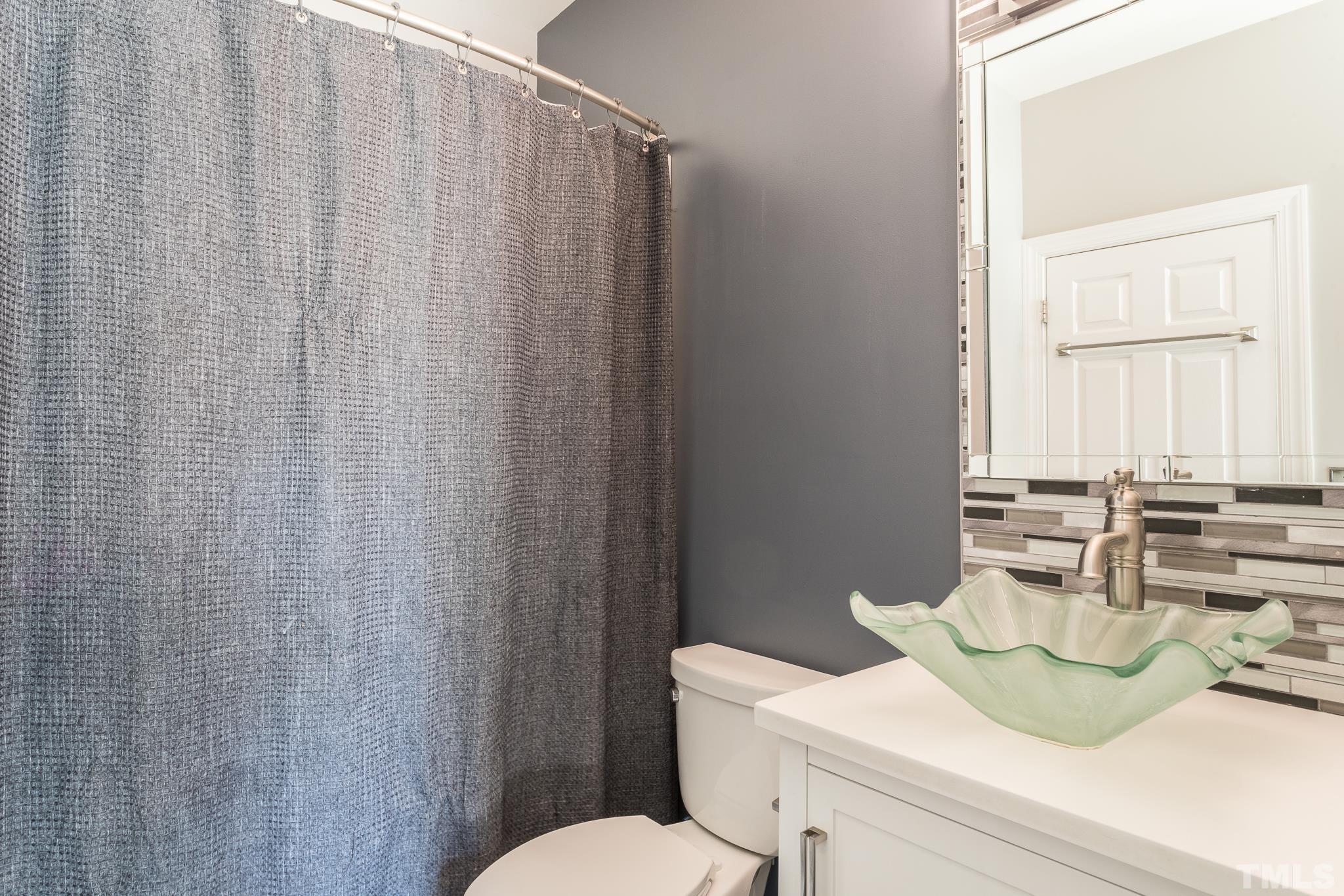 6023 Clapton Drive Wake Forest, NC 27587 - Photo 21 of 35 a bathroom with a sink vanity mirror and toilet