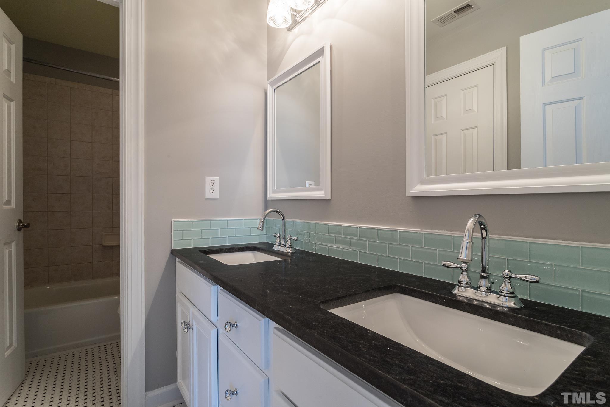 6023 Clapton Drive Wake Forest, NC 27587 - Photo 31 of 35 a bathroom with a sink and a mirror