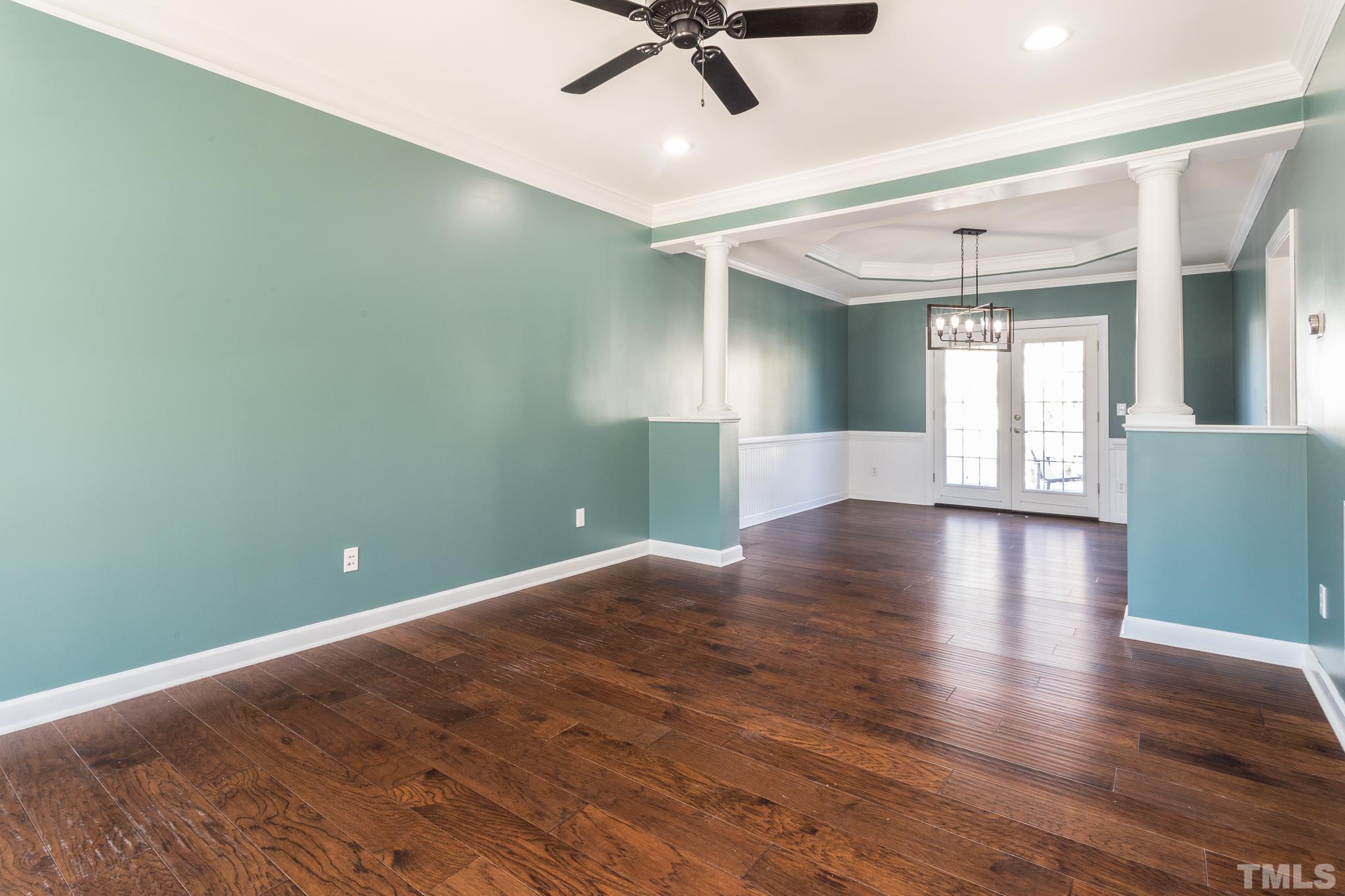 6023 Clapton Drive Wake Forest, NC 27587 - Photo 4 of 35 a view of a livingroom with wooden floor and a ceiling fan