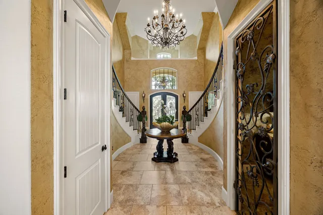 a view of a dining room with furniture and a chandelier