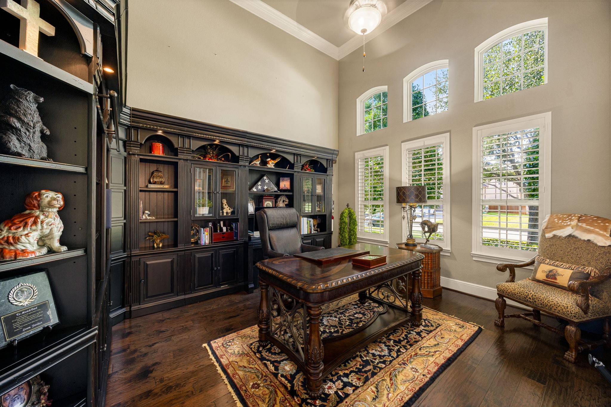 26515 Ashley Ridge Lane Katy, TX 77494 - Photo 8 of 50 This elegant home office features high ceilings, hardwood flooring, and large windows with plantation shutters creating a sophisticated and inviting workspace.