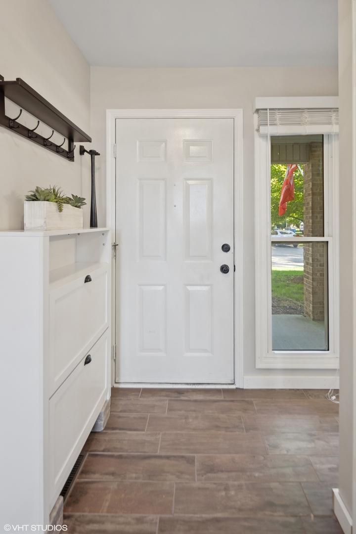 449 Wenbriar Square Addison, IL 60101 - Photo 2 of 35 a view of an empty room with window and cabinet
