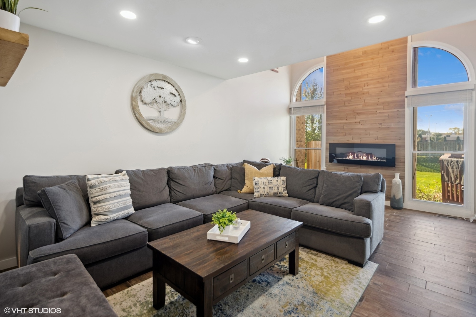 449 Wenbriar Square Addison, IL 60101 - Photo 3 of 35 a living room with furniture a lamp wooden floor and a fireplace