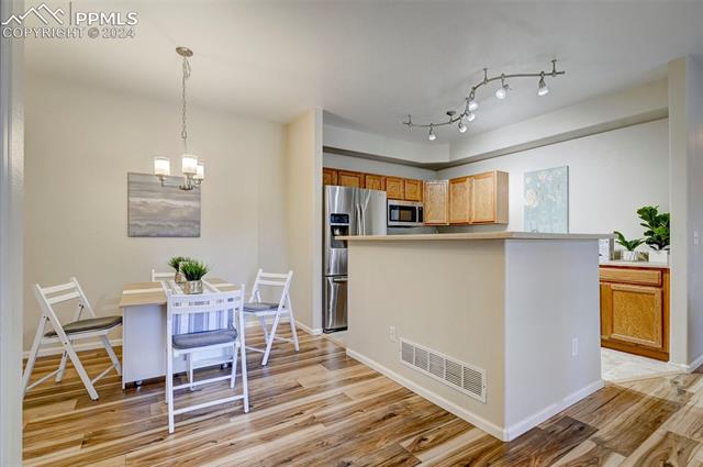 2094 Legacy Ridge View, Unit 107 Colorado Springs, CO 80910 - Photo 4 of 19 The dining and kitchen space flow effortlessly together.