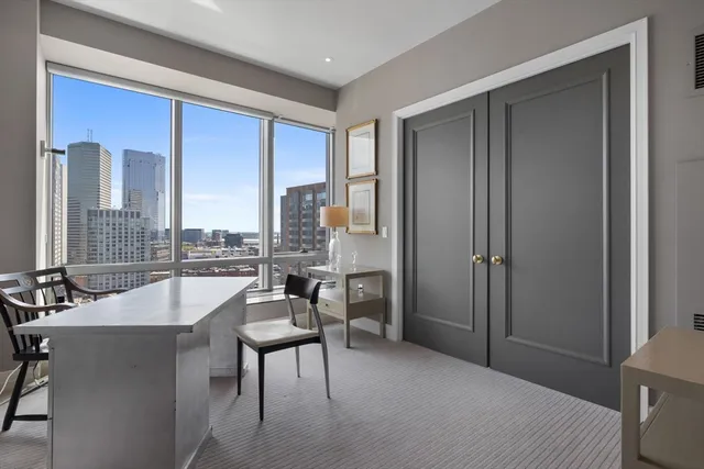 a very nice looking living room with a large window and furniture