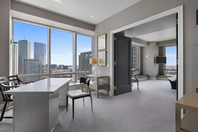 a bed sitting in a bedroom next to a large window