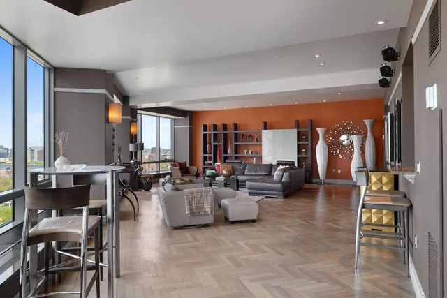 a living room with furniture and large windows