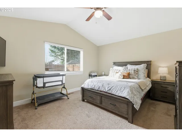 a spacious bedroom with a bed and a window
