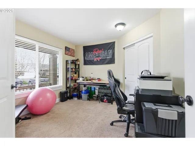 a view of a workspace with furniture and a window