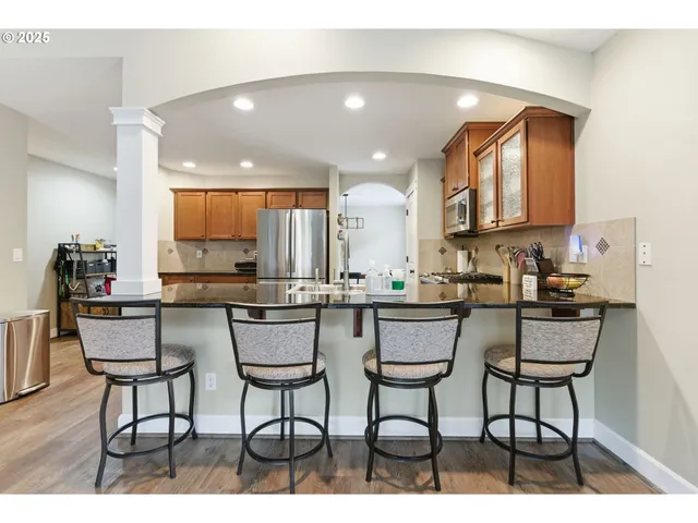 a kitchen with a dining table chairs and window