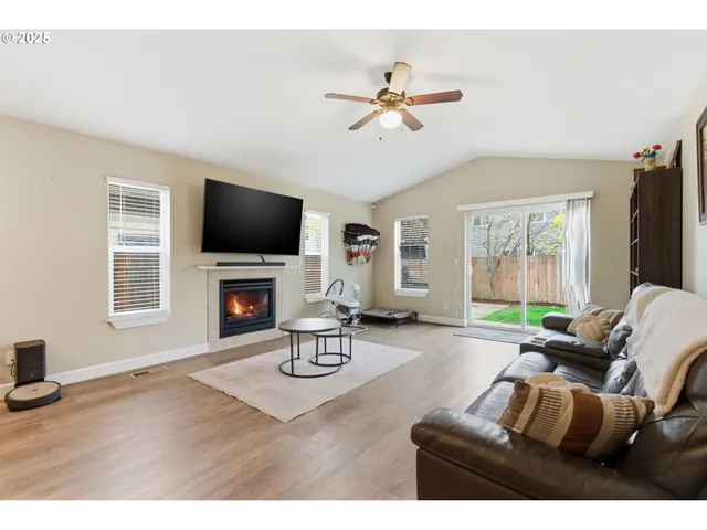 a living room with furniture a fireplace and a flat screen tv