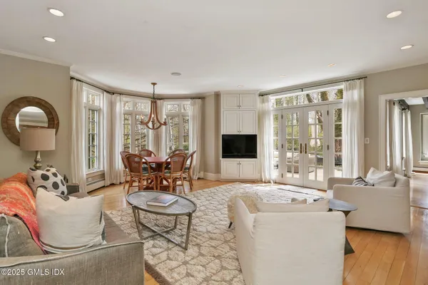 a living room with furniture and a floor to ceiling window