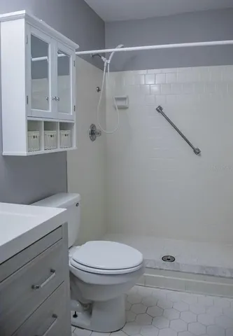a bathroom with a toilet and a shower