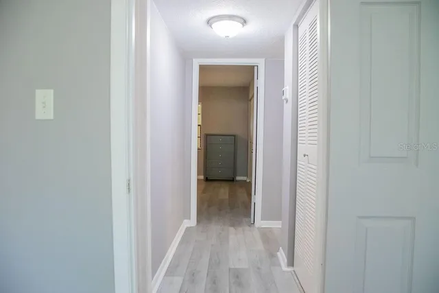 a view of a hallway with wooden floor