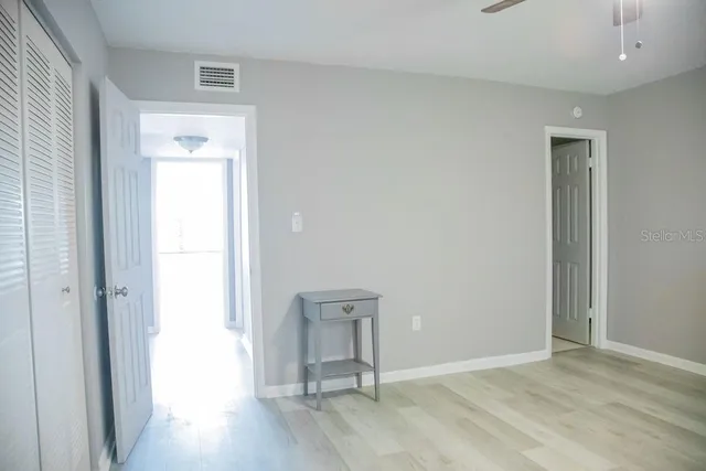 a view of an empty room and wooden floor