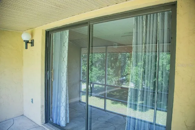 a view of a glass door and the balcony