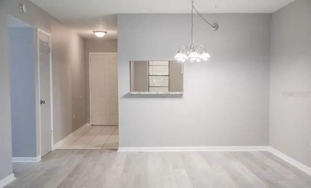a view of a chandelier fan and wooden floor