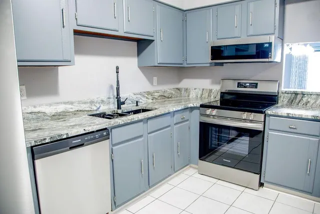 a kitchen with appliances cabinets and a sink