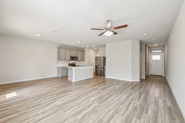 a view of a kitchen with a sink and wooden floor