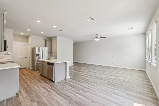 a view of kitchen with granite countertop cabinets and wooden floor