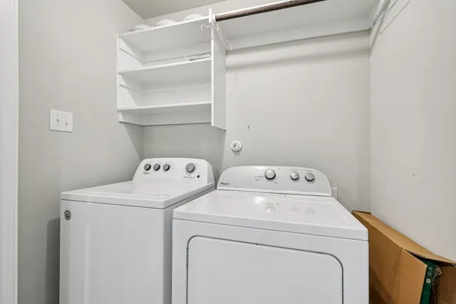 an empty room with ceiling fan and windows
