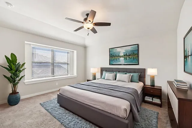 a bedroom with a large bed and a chandelier