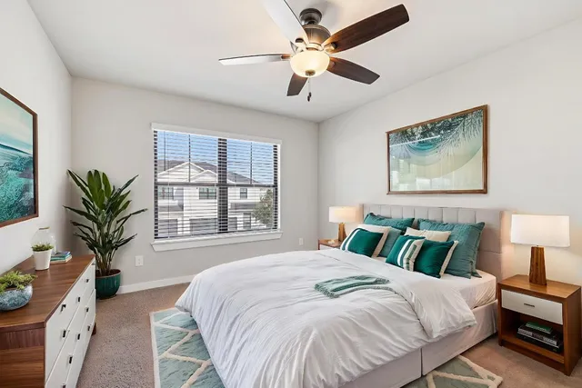 a bedroom with a large bed and a chair