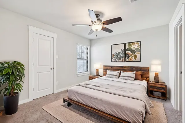 a bedroom with a bed and a potted plant