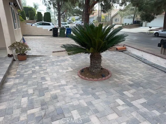a view of a street with potted plants