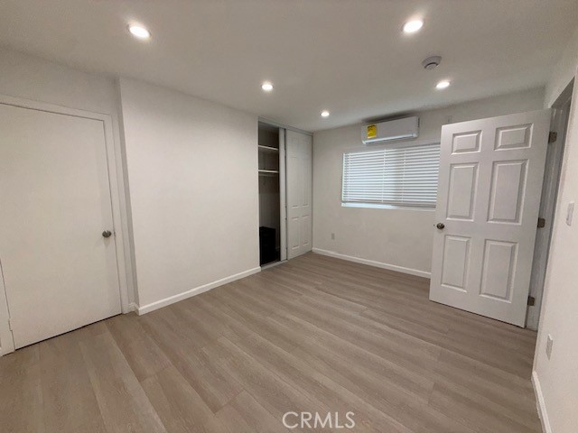 18419 Tuba Street Northridge, CA 91325 - Photo 11 of 15 an empty room with wooden floor and windows
