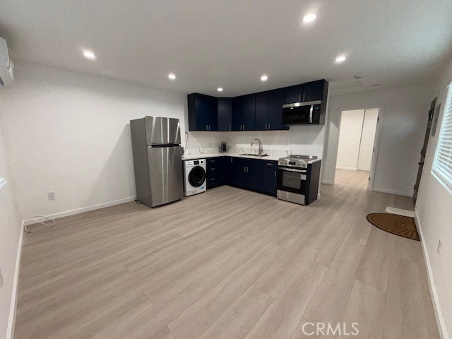 18419 Tuba Street Northridge, CA 91325 - Photo 6 of 15 a kitchen with stainless steel appliances kitchen island granite countertop a refrigerator and a stove top oven