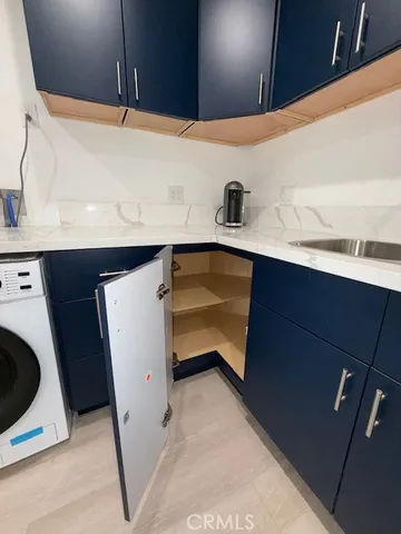 a kitchen with a sink a stove and cabinets